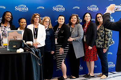 CHWE Attendees Posing with the Sigma banner