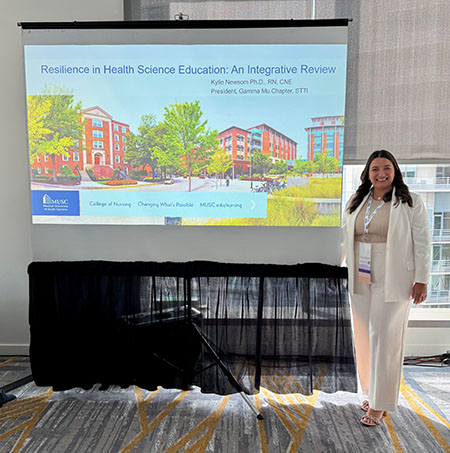 Kylie Newsom in front of her presentation at congress.